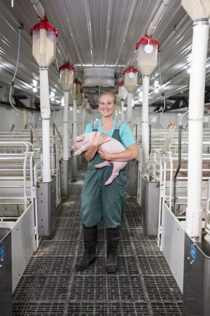 woman holding a pig